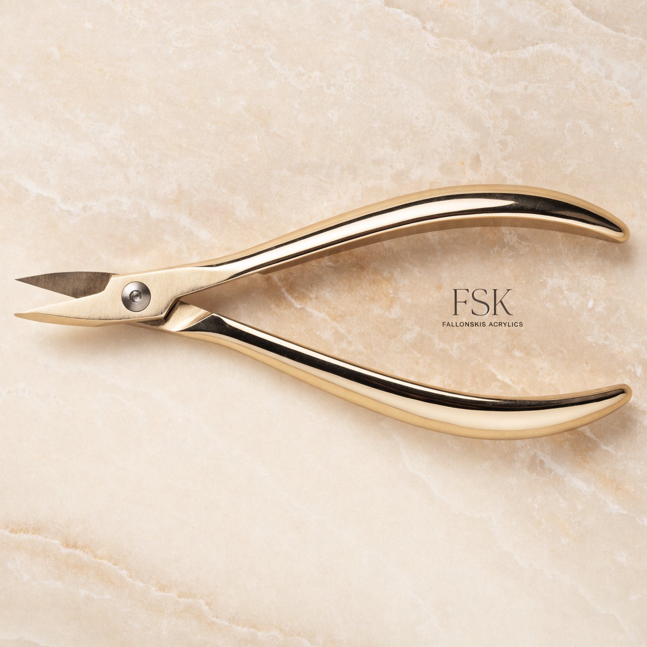 FSK gold engraved nail tool on marble