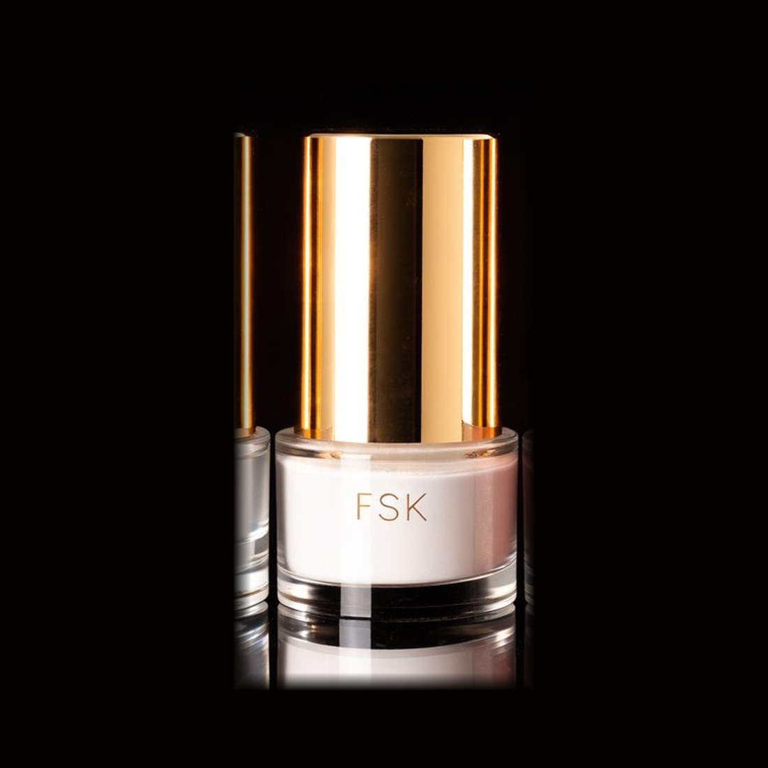 FSK White acrylic core powder in a clear jar with a gold lid